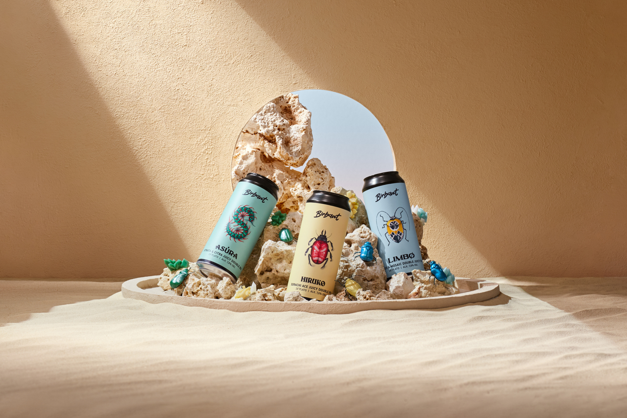 Photo of beer cans on sand scene